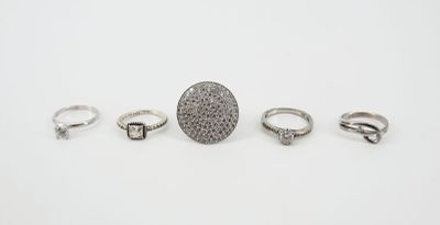 a group of five rings and a ring on a white surface