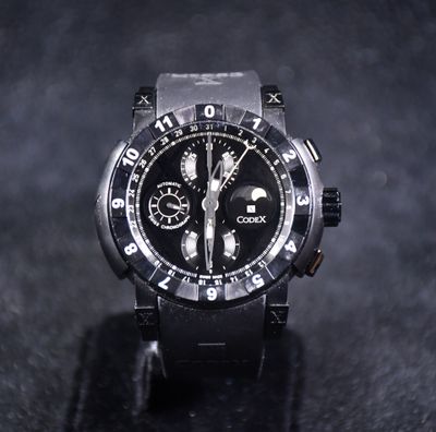 a close up of a black watch on a black surface