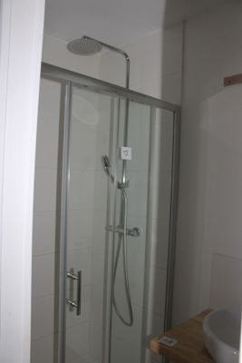 a bathroom with a shower and a sink in it