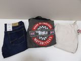 two pairs of jeans and a t - shirt on a table
