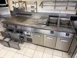 a large commercial kitchen with stainless steel appliances in it