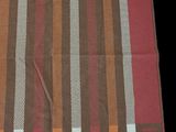 an orange, brown, and white striped blanket on a black background