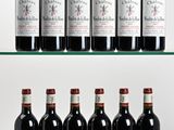 six bottles of red wine are lined up on a glass shelf