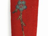 embroidered red case with a bird on a branch of a tree