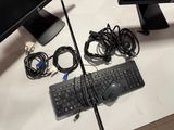 a keyboard, mouse, and monitor on a desk