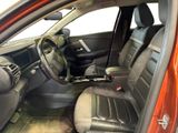 the interior of a car with the door open and the driver ' s seat down