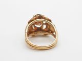 a close up of a gold ring on a white surface
