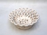a small white bowl with a flower inside of it