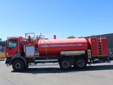 a large red truck that is parked in a parking lot