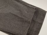 a close up of a pair of grey pants on a white surface