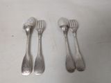 three forks and two spoons sitting on a table