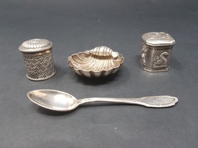 a spoon, salt shaker, and spoon sitting on a table