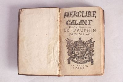 un livre ouvert sur lequel figure l'image d'un blason et un blason