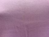 a close up of a purple shirt with a small hole in the middle