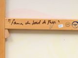 a picture of a wooden sign with writing on it
