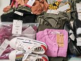 a pile of clothes and shoes on a table