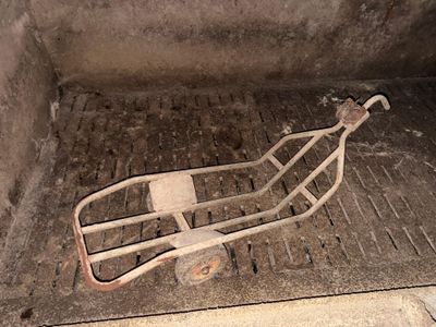 a small cart sitting in the middle of a dirty floor