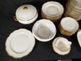 a lot of plates and bowls that are on a table
