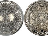 a close up of two silver coins on a white background