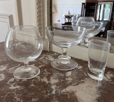 several empty wine glasses are sitting on a marble counter top