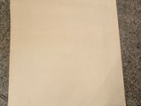 a piece of paper on the floor next to a pair of scissors
