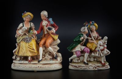 deux figurines représentant des personnes assises sur une surface noire