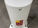 a white trash can sitting on the floor in a warehouse