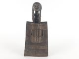 an image of a statue of a woman sitting on top of a piece of wood