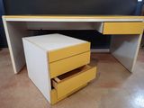 a yellow and white desk with two drawers on it