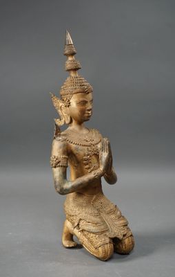 an image of a statue of a person kneeling on a gray surface