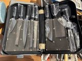 a case of knives and knives in it on a table