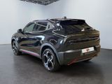 the rear end of a black suv parked in a showroom