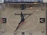 a close up of a silver watch with a black face