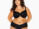 une femme en soutien-gorge et culotte noirs posant pour une photo
