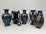 five vases sitting next to each other on a table