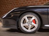 a black sports car parked in front of a brick wall