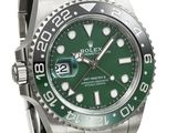 the rolex watch is green and silver with a black bezel