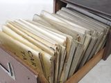 a lot of old papers in a drawer on the floor