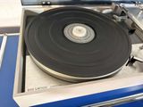 a record player sitting on a turntable in a room