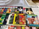 a lot of magazines on a bed with a white sheet