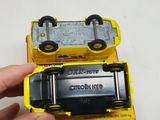 a person holding a yellow toy truck in their hand