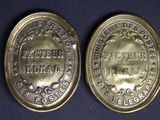 two silver coins with the names of different countries on them