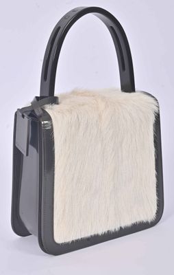 black and white handbag with fur inside on a white background