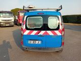 a blue van with a surfboard on top of it