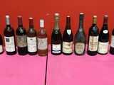 many bottles of wine on a pink table cloth
