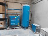 a large blue tank sitting in a room next to a table