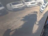 a close up of a car with a shadow on the side of it
