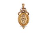 a close up of a gold pendant on a white background