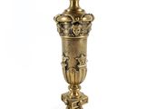 pair of antique brass candlesticks with ornate designs on each side
