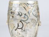 a glass vase with a design on it on a table